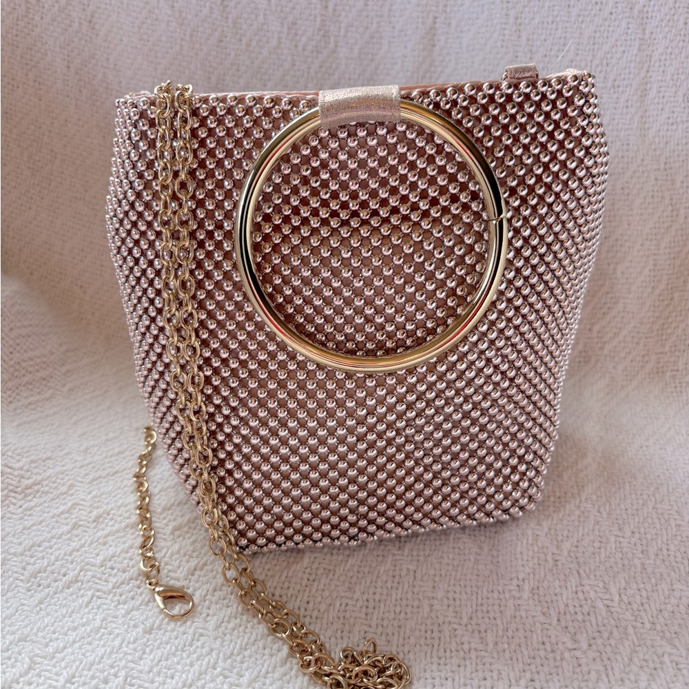 Elegant blush pink rose gold mesh evening bag with circular handles